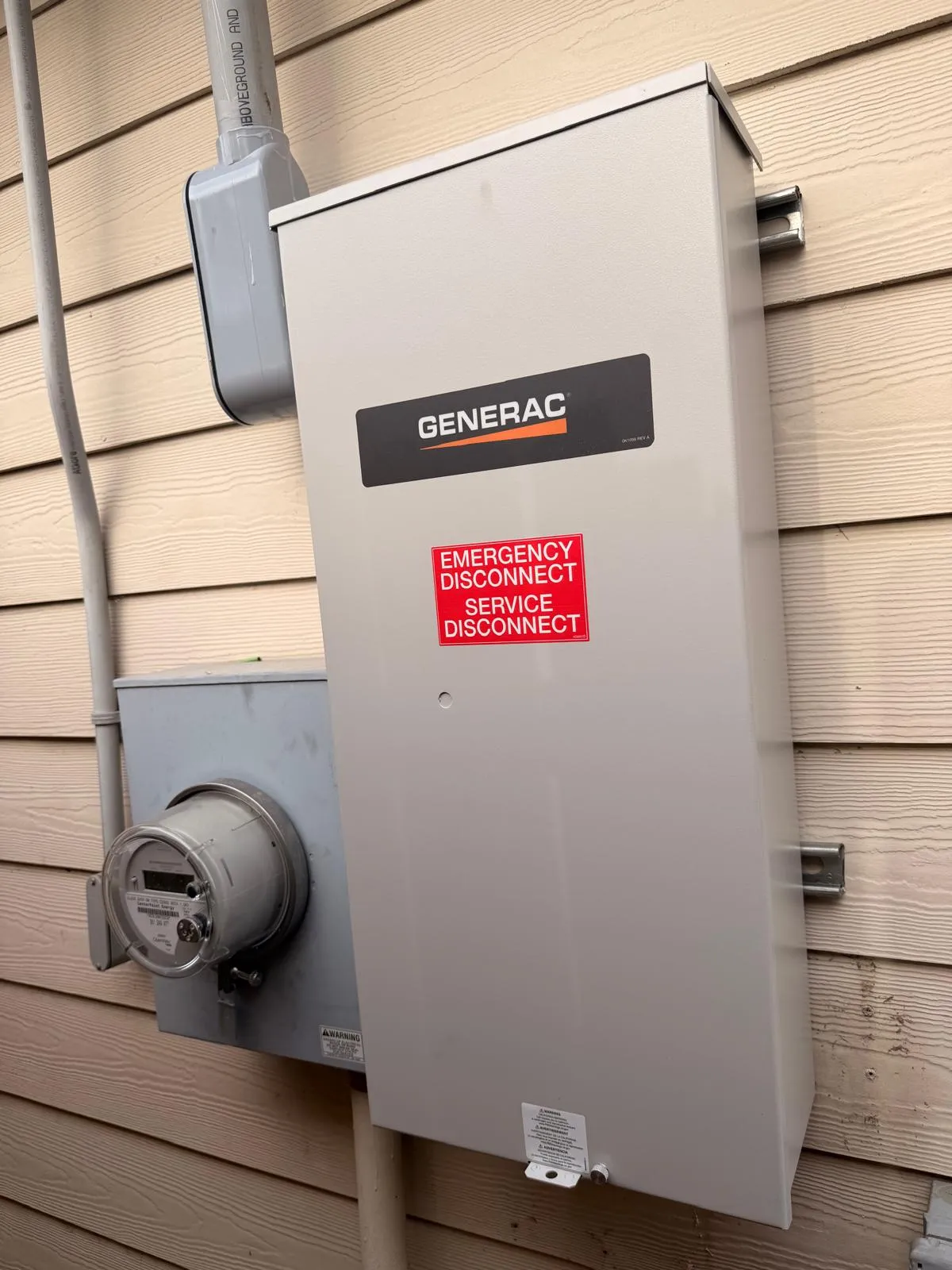 Generac emergency service disconnect installed beside electric meter