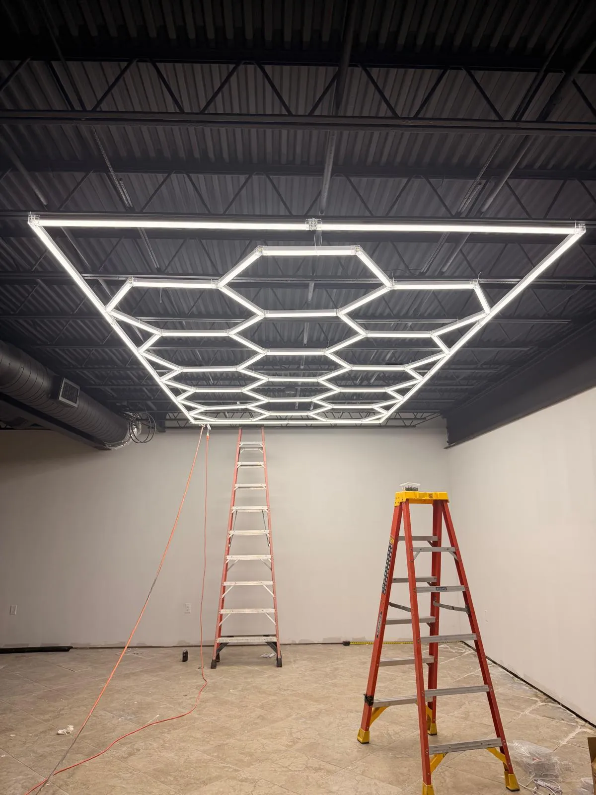 Finished hexagon LED ceiling grid glowing in a commercial space